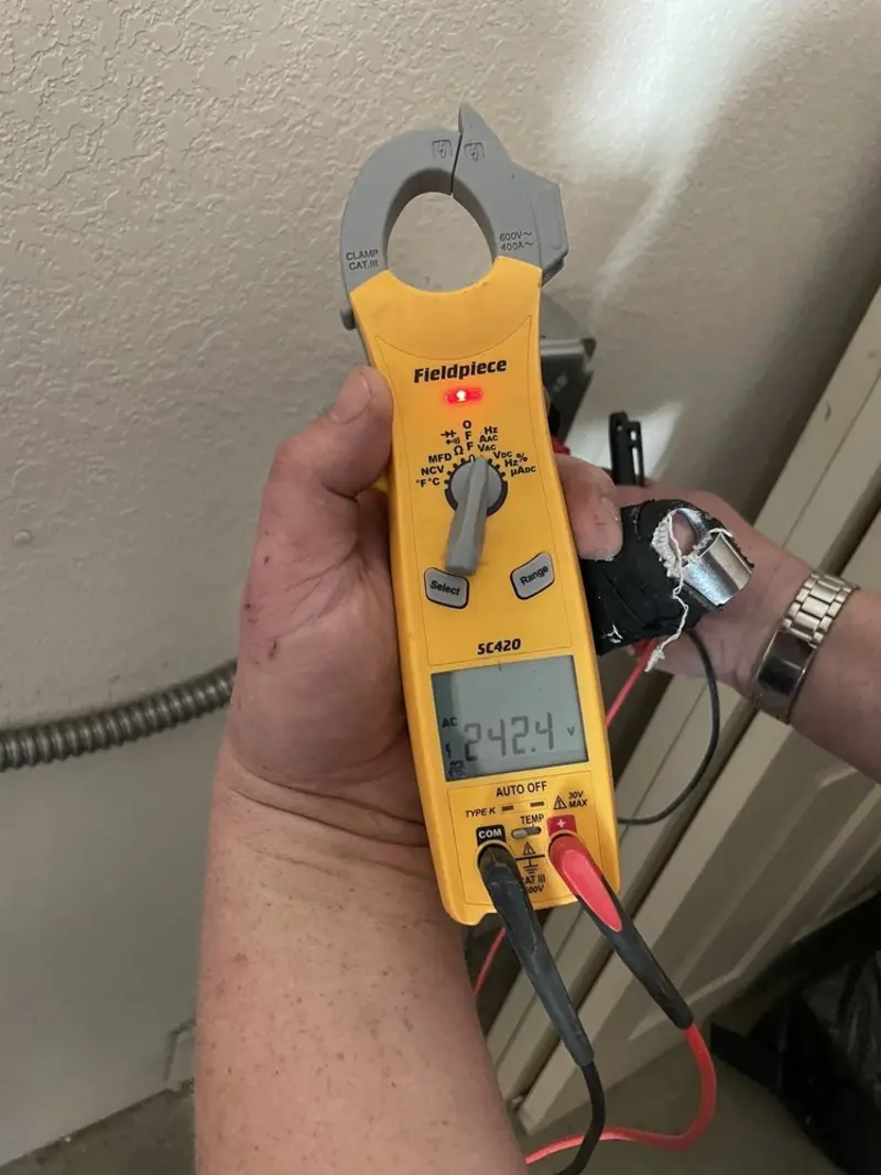 Voltage testing with clamp meter during Outlet Installation in Highland Park
